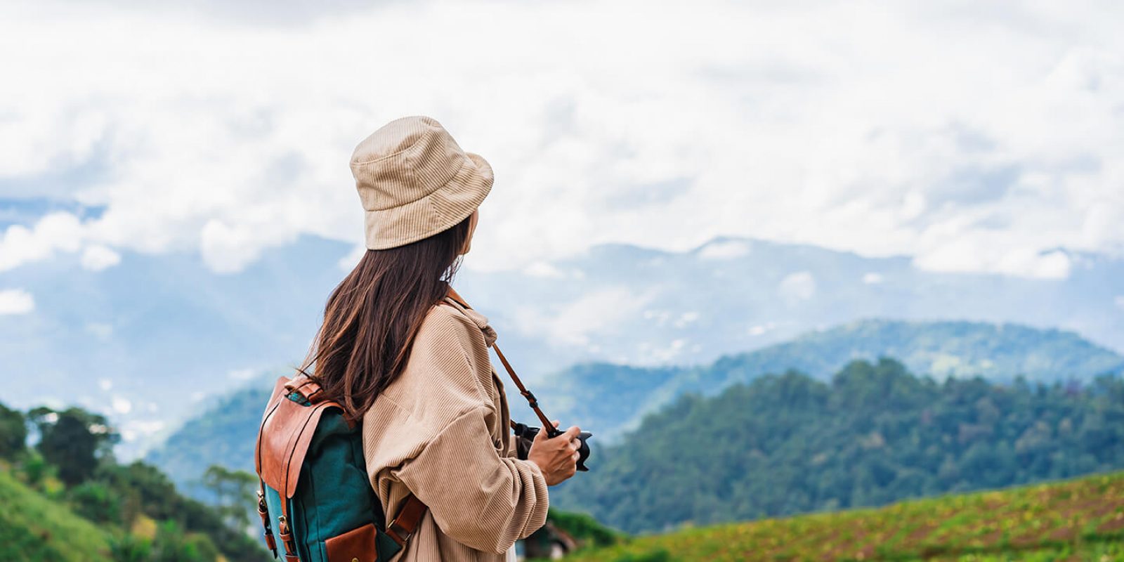 young-woman-traveler-taking-a-beautiful-landscape